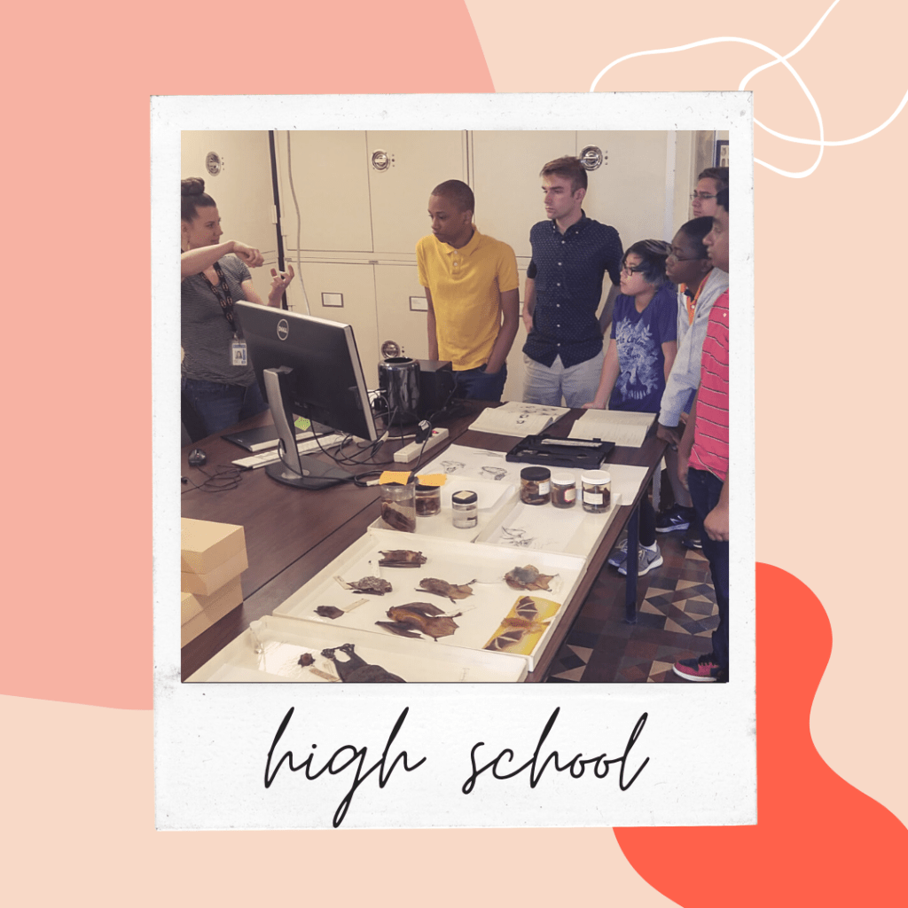 image of teens listening to a person talking over a table full of scientific specimens. 