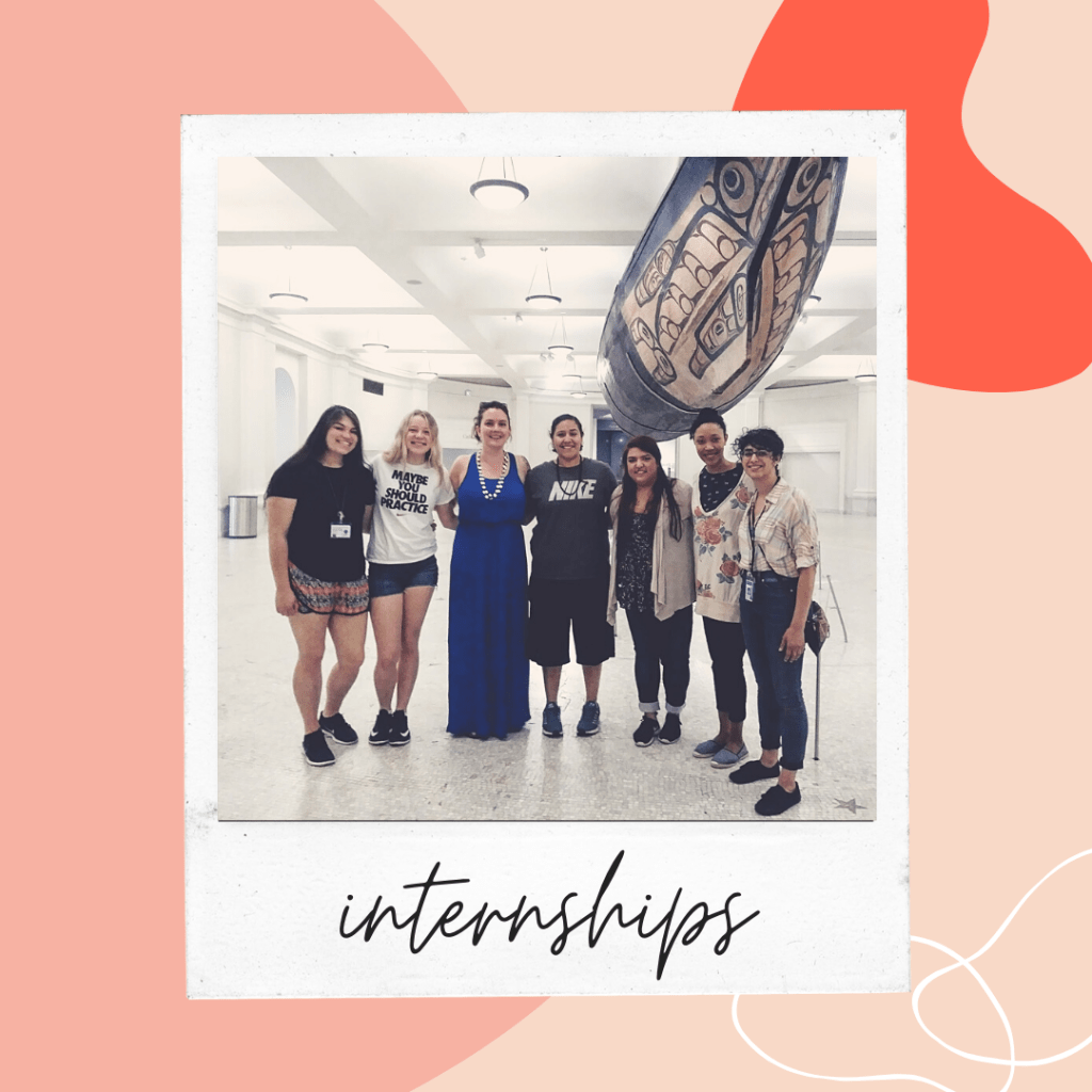a group of women gathered under a large canoe.
